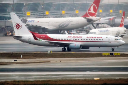 Air Algerie Boeing aircraft in the apron, white and red livery. A Turkish Airlines aircraft behind it.