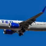 United Airlines Boeing 737 MAX 9 flying in clear blue skies
