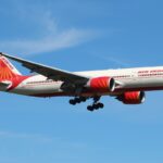 Air India's Boeing 777 close to landing at London Heathrow Airport during a sunny day.