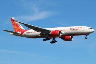 Air India's Boeing 777 close to landing at London Heathrow Airport during a sunny day.