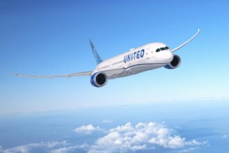 United Airlines Boeing 787- Dreamliner flying through a clear blue sky
