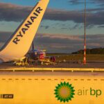 Ryanair aircraft tail in view, BP truck refuelling Ryanair Boeing 737-800 at sunrise.