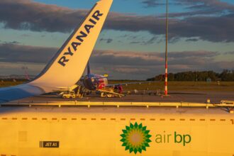 Ryanair aircraft tail in view, BP truck refuelling Ryanair Boeing 737-800 at sunrise.
