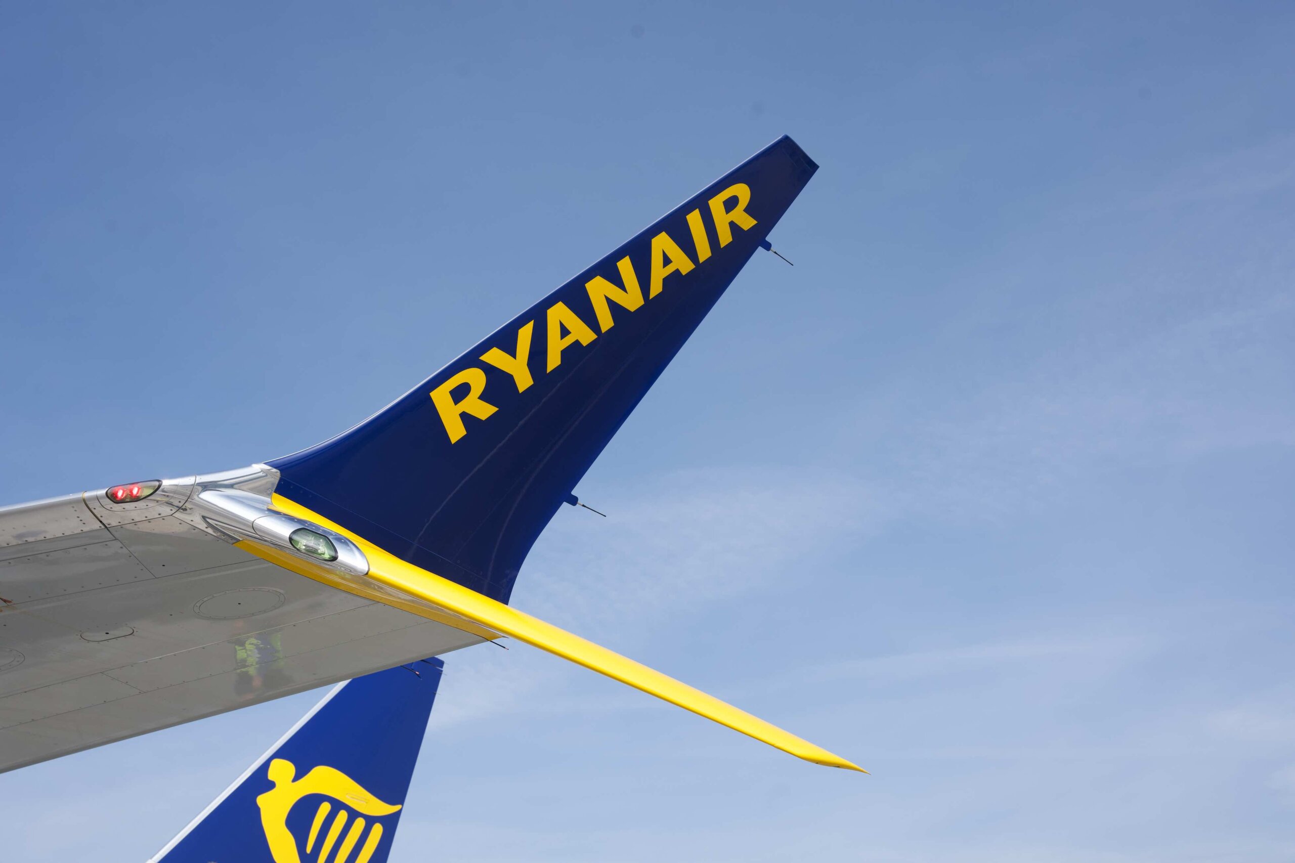 A close-up image of a Ryanair aircraft winglet displaying the airline’s iconic branding during flight operations. Ryanair remains one of Europe’s largest low-cost carriers, operating an extensive network of short-haul routes across the continent.