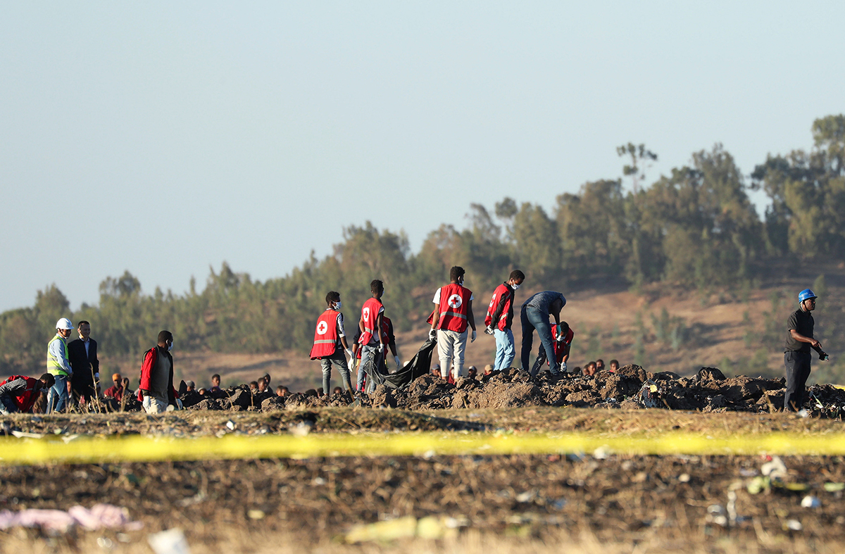 Search and rescue workers recover bodies from the wreckage of Ethiopian Airlines crash
