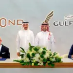 beOnd CEO Tero Taskila and Gulf Air CEO Martin Gauss signing the codeshare and loyalty partnership agreement, with Bahraini government officials present at the ceremony.