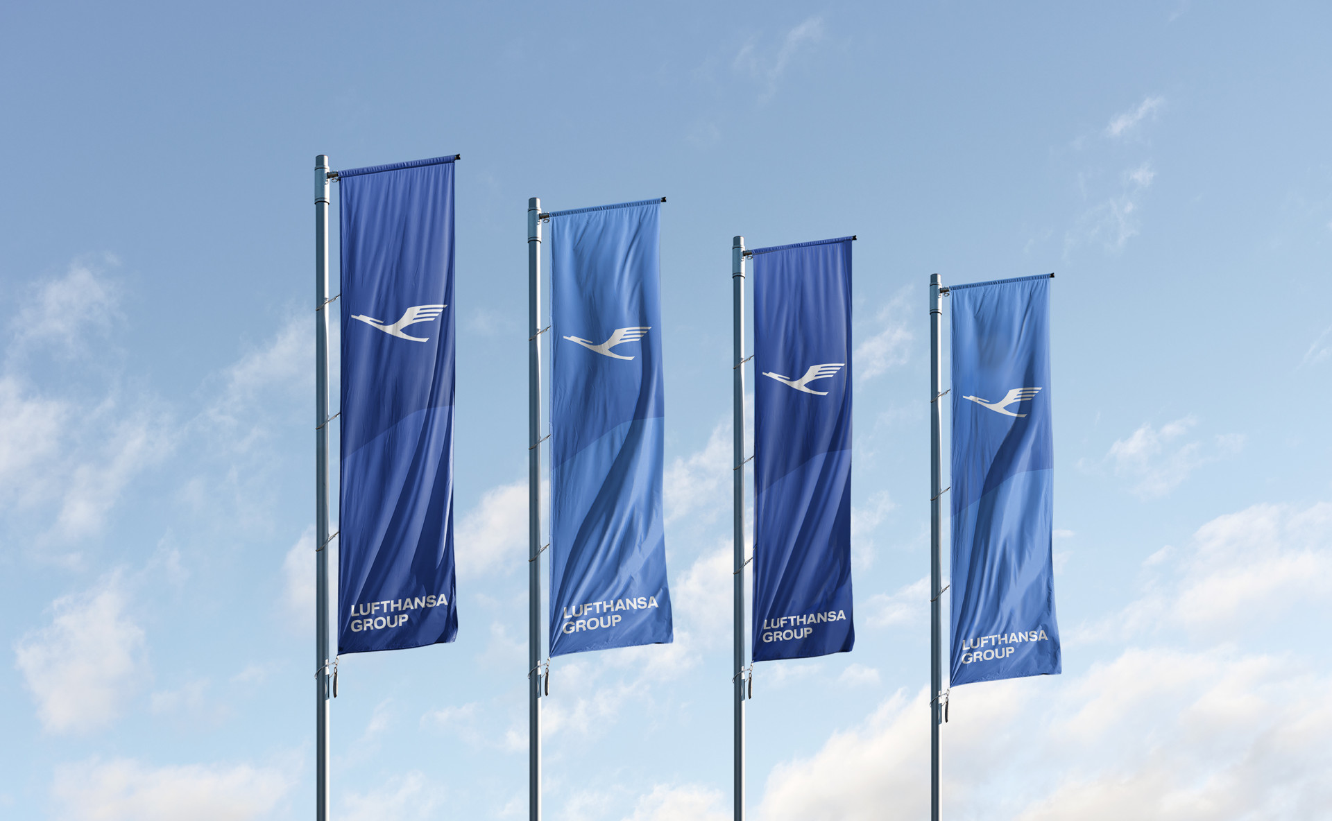 Blue Lufthansa Group banners displaying the companies logo flying in the wind