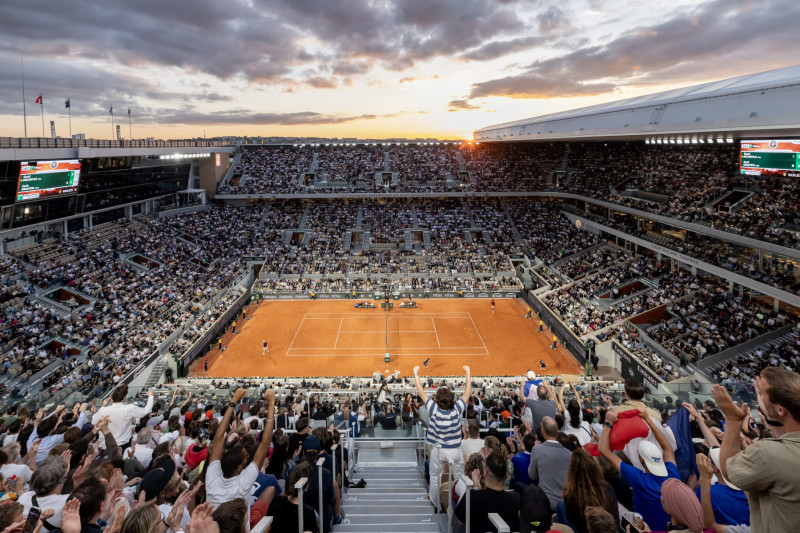 Lateral view of Philippe-Chatrier arena being crowded and at sunset