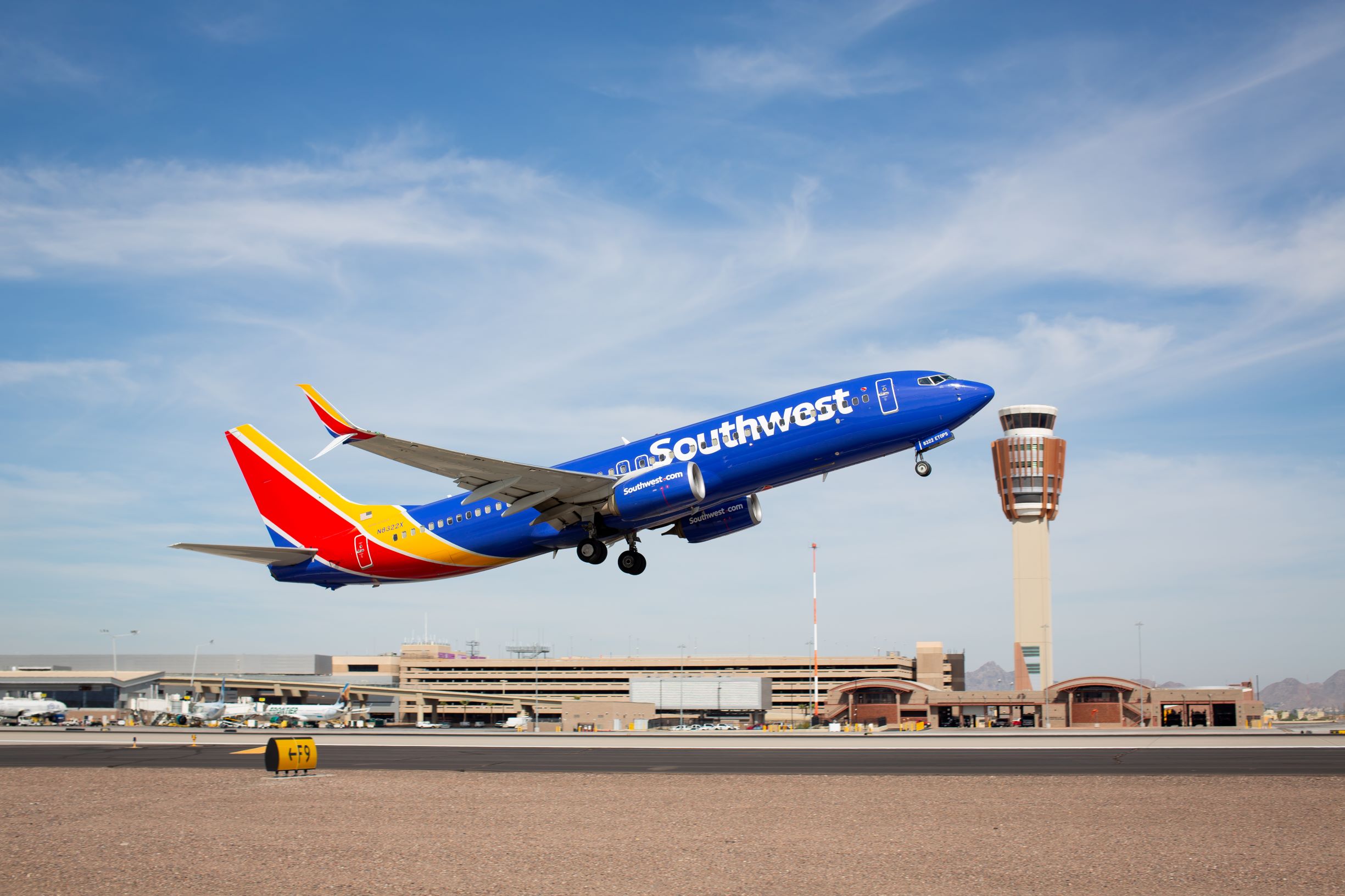 An image of a Southwest aircraft lifting off from the runway.