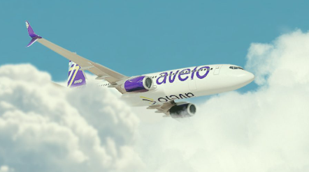 A large white plane flying through a blue sky with clouds