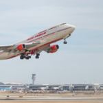A large jetliner flying though a blue sky
