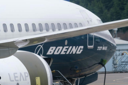 A large blue and white Boeing 737 jetliner sitting on the tarmac.