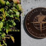 A brown plaque on a concrete wall reading 'Federal Aviation Administration'
