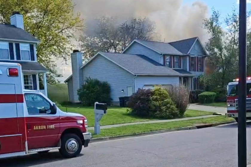 A grey house with smoke rising from the top