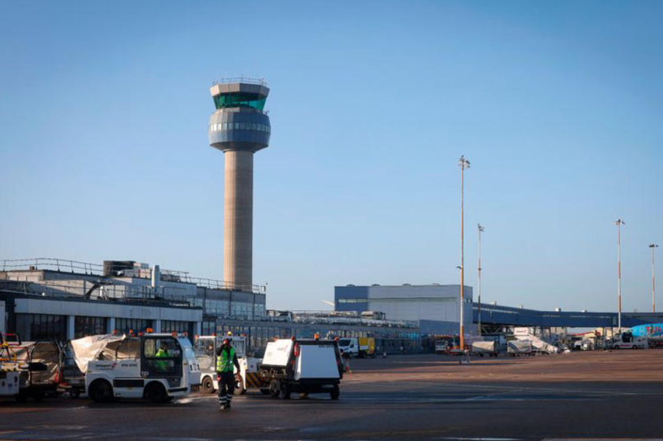 An airport runway with an air traffic control tower