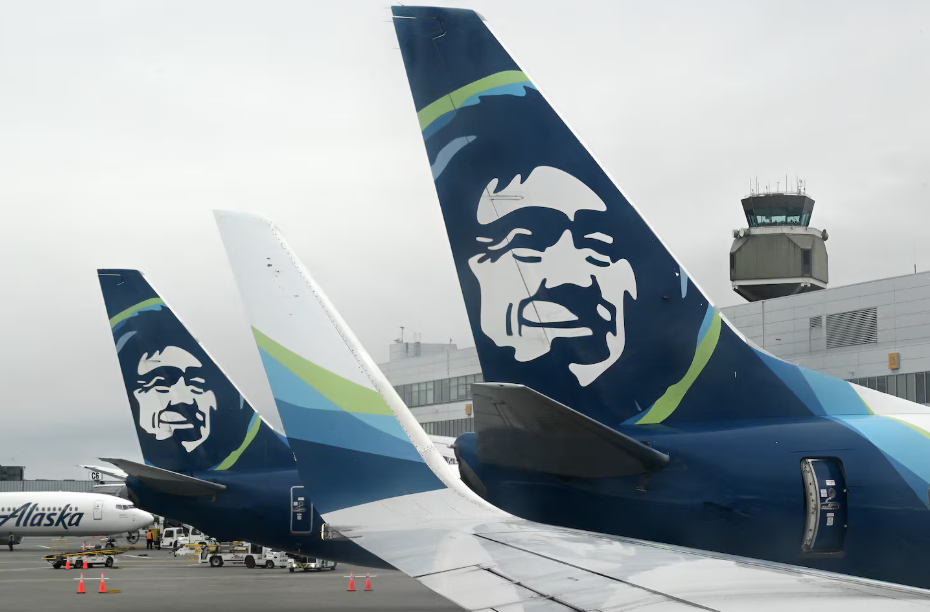 Two large blue and white jetliners sitting on a runway