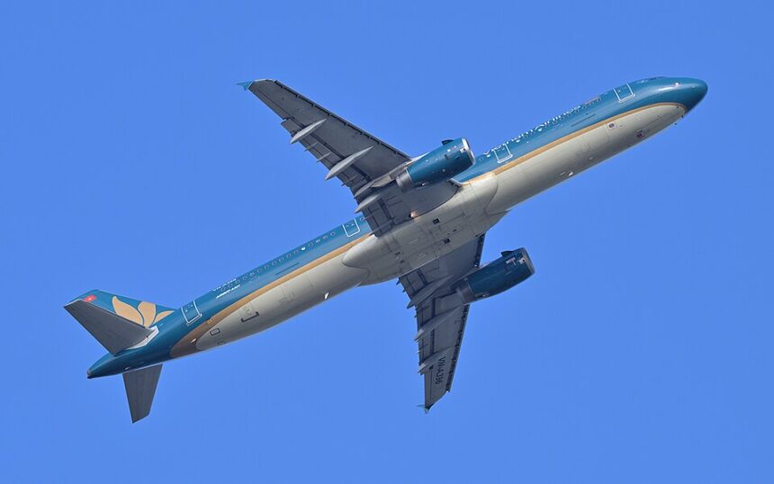 Vietnam Airlines Airbus A321 VN-A396, operating flight 579 to Hanoi, departs Taiwan Taoyuan International Airport from runway. On blue sky