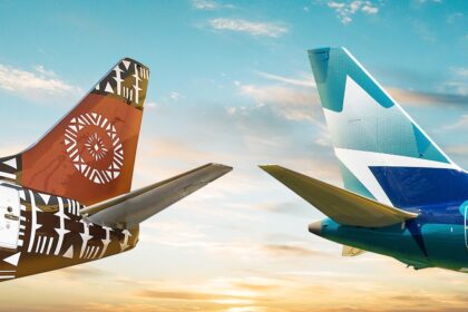 Tails of WestJet and Fiji Airways aircraft, displaying their brown and blue hues and logos.