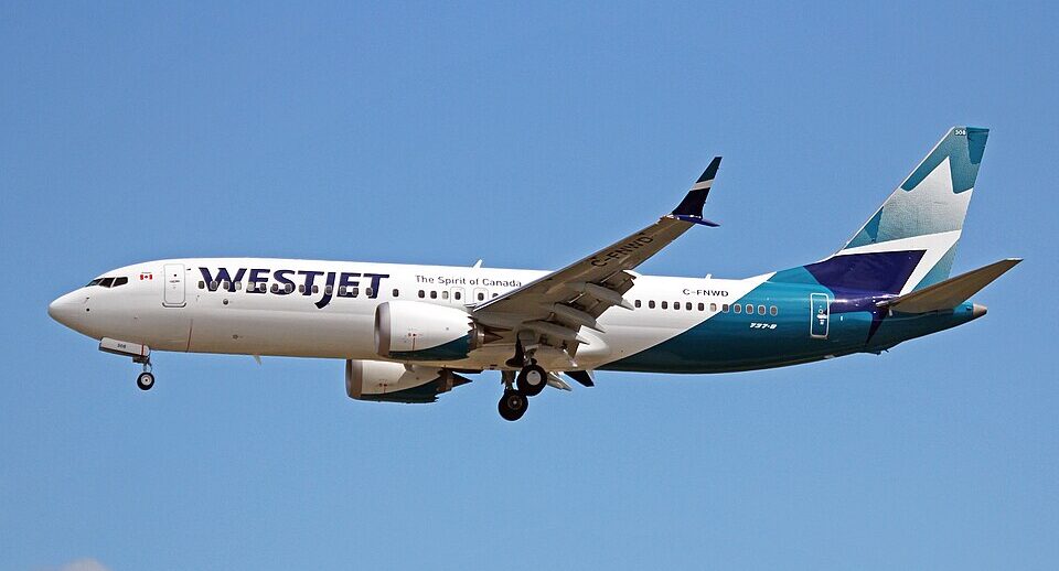 WestJet's Boeing 737-Max flying in clear blue skies to Vancouver