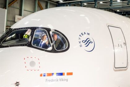SAS Airbus A350 named ‘Frederik Viking’ during naming ceremony, with two men visible inside the cockpit waving from the aircraft window.