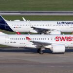 Swiss International Air Lines Airbus A220-100 HB-JBA taxiing past a Lufthansa Airbus A320-200 D-AIUL on an adjacent taxiway.