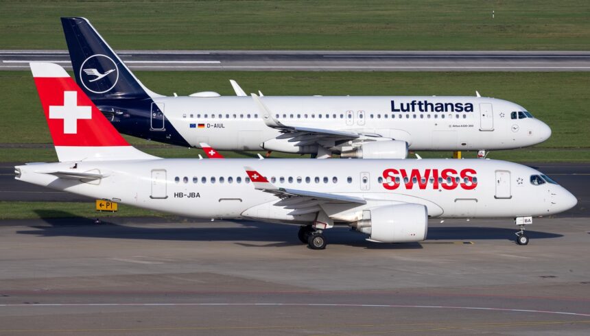 Swiss International Air Lines Airbus A220-100 HB-JBA taxiing past a Lufthansa Airbus A320-200 D-AIUL on an adjacent taxiway.