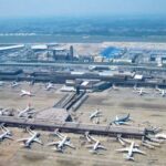 Aerial shot of Japanese airport, rows of planes on tarmac