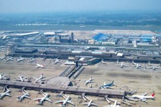 Aerial shot of Japanese airport, rows of planes on tarmac