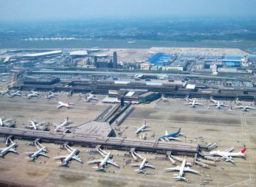 Aerial shot of Japanese airport, rows of planes on tarmac