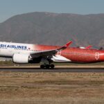 Turkish Airlines Airbus A350 TC-LHH in special 500th aircraft livery taxiing on runway with mountains in the background.