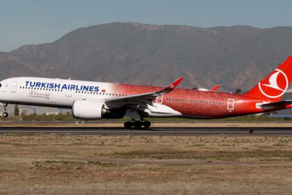 Turkish Airlines Airbus A350 TC-LHH in special 500th aircraft livery taxiing on runway with mountains in the background.