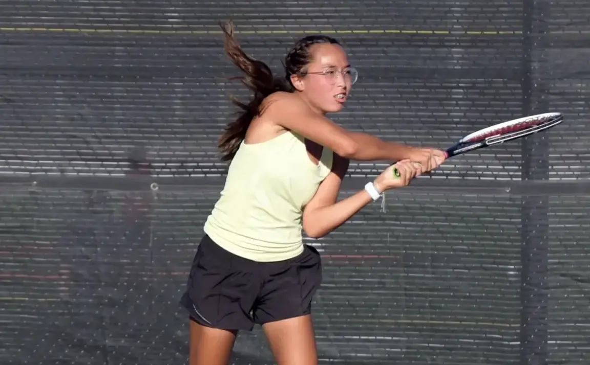 Seren Wilson playing pickleball outside. Racket in hand, mid-swing.