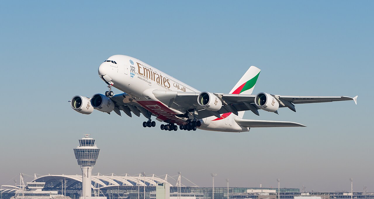 Emirates Airbus A380-861 passenger aircraft taking off from the runway at Munich Airport.