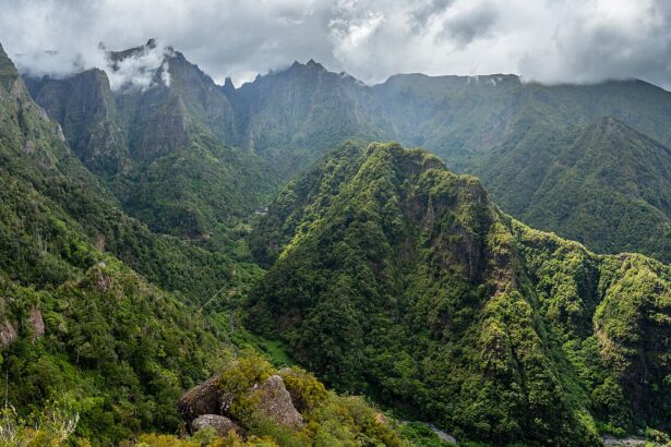 View from the valley Balcões, São Roque do Faial, Santana, Madeira. The sky is very cloudy and the view is filled with mountains covered in trees.