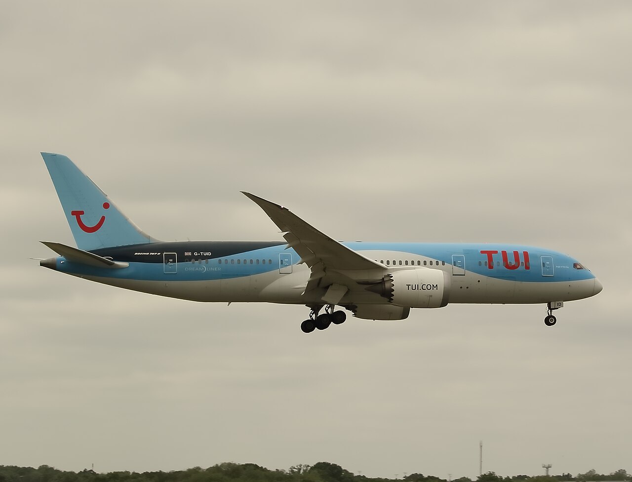 Tui Boeing 787-9 in flight against a cloudy sky
