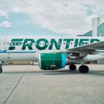 Frontier logo on aircraft from the side angle on the airport tarmac