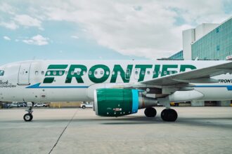 Frontier logo on aircraft from the side angle on the airport tarmac