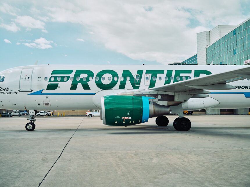 Frontier logo on aircraft from the side angle on the airport tarmac