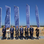 eight people stand in front of Lufthansa flags at the construction site including managing directors and CEOs