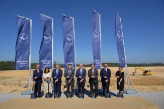 eight people stand in front of Lufthansa flags at the construction site including managing directors and CEOs