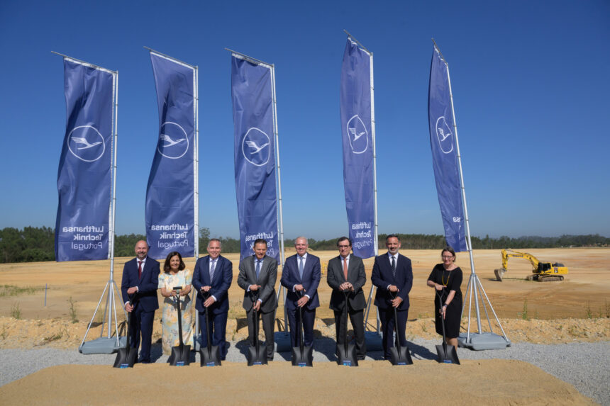 eight people stand in front of Lufthansa flags at the construction site including managing directors and CEOs