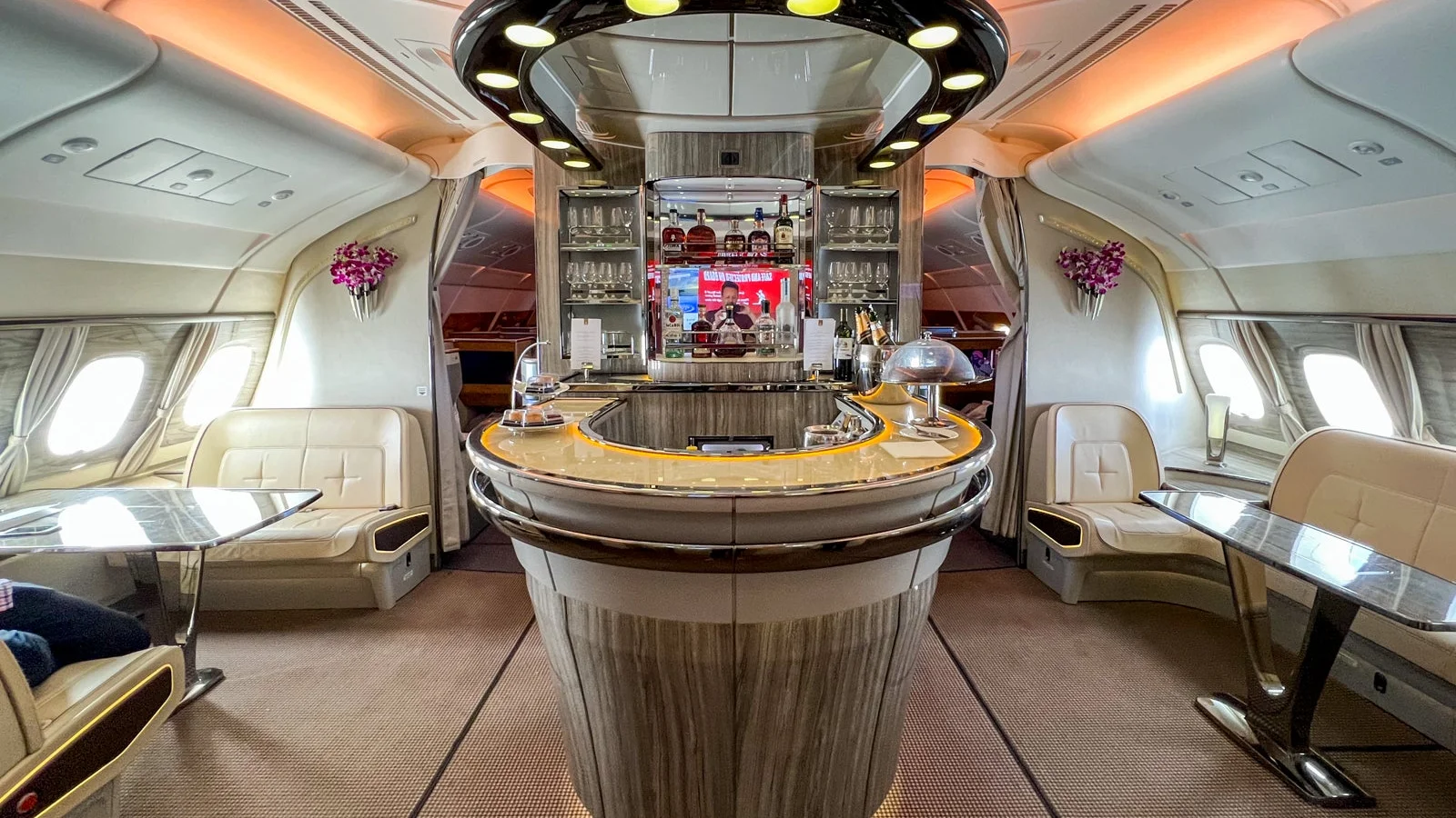 Interior of the Emirates A380 Onboard Lounge decorated for passenger service, expected on typical route journey.
