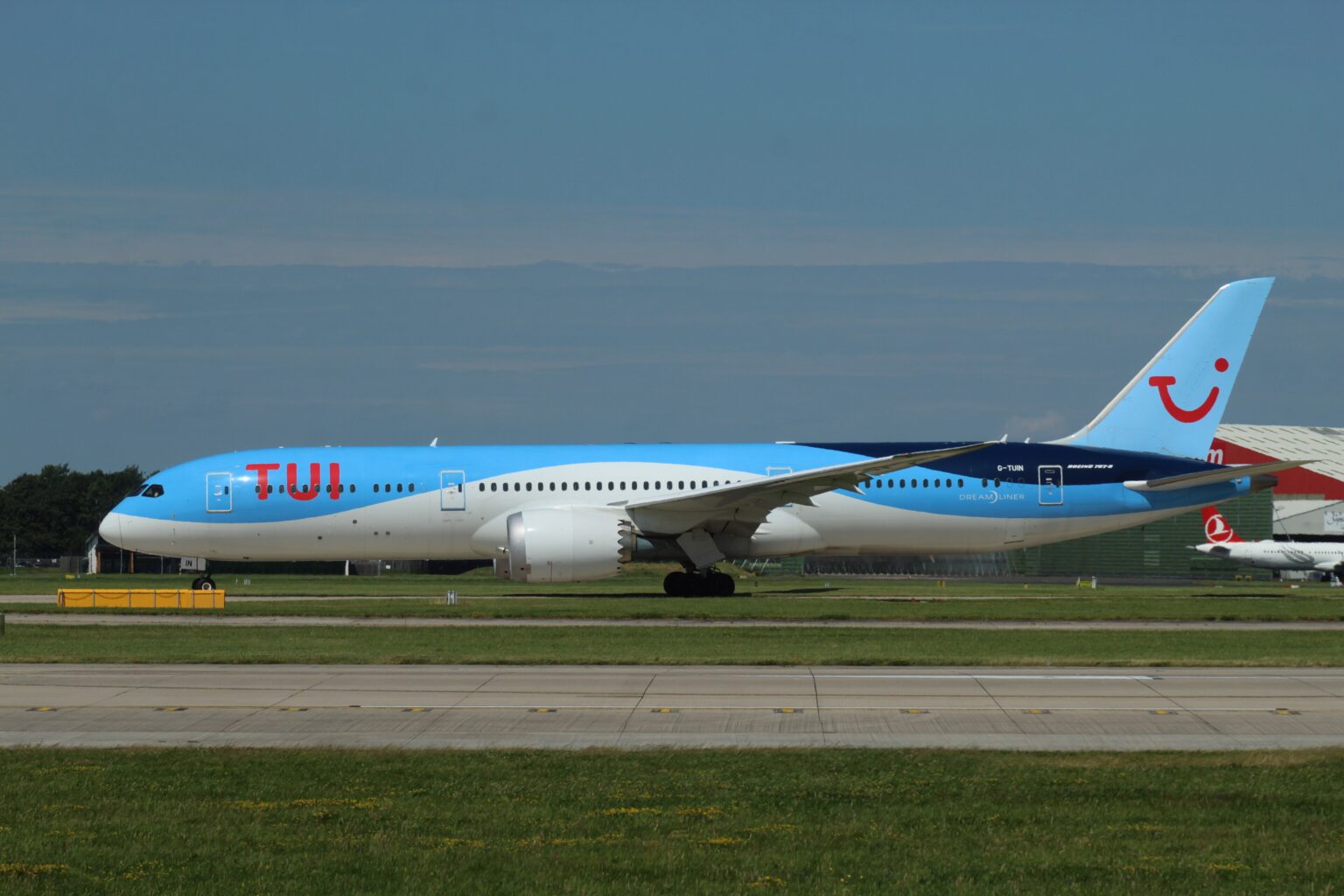 Tui Boeing 787-9 with blue and white fuselage on the runway against a clear-blue sky