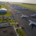 A line of Cessna Citation and Beechcraft aircraft parked on an airport apron as volunteer pilots prepare for the Special Olympics Airlift mission