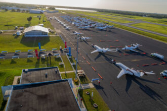 A line of Cessna Citation and Beechcraft aircraft parked on an airport apron as volunteer pilots prepare for the Special Olympics Airlift mission