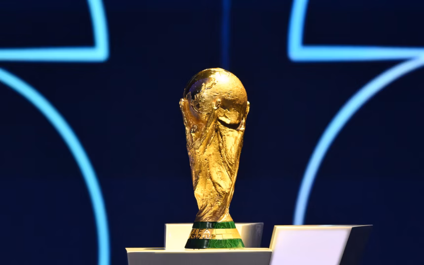 FIFA World Cup trophy on a stand with a blue back drop.
