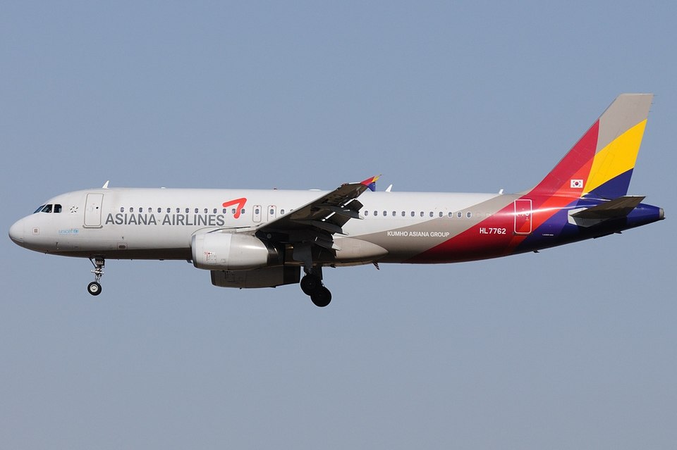 Asiana Airlines Airbus A320 in flight against a blue sky
