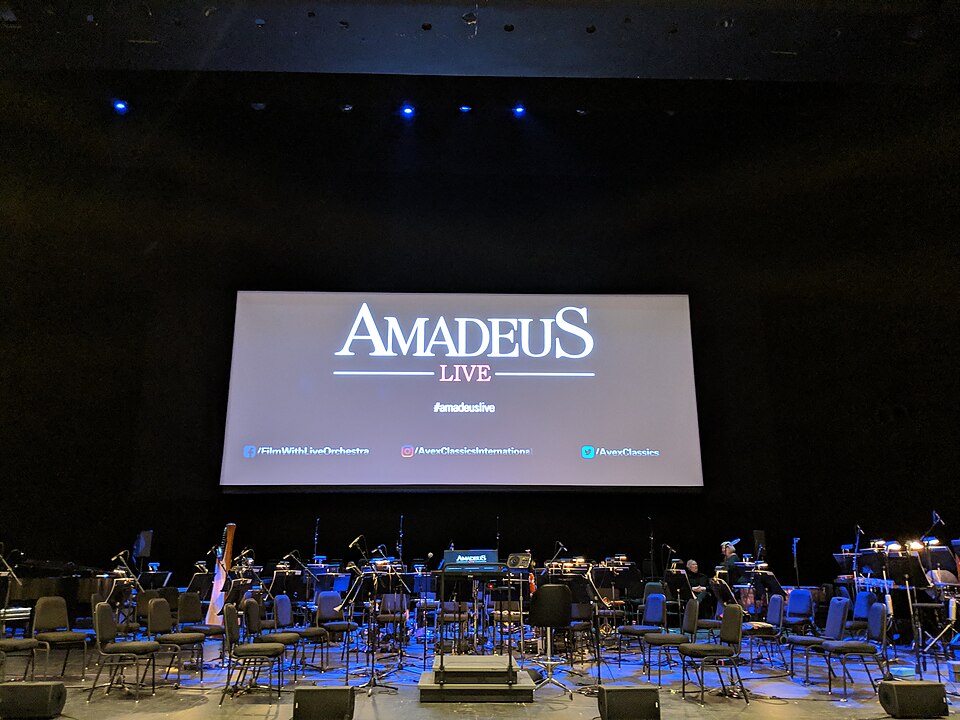 A photo of an Amadeus display at a travel technology event, showing the company branding and signage used to illustrate airline systems that support premium in-flight connectivity upgrades.