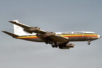 A Uganda Airlines Boeing 707-351C in the airline’s iconic black, yellow and red livery descends for landing. The image highlights the carrier’s aviation heritage as Uganda Airlines embarks on a new era of fleet expansion with Boeing aircraft.