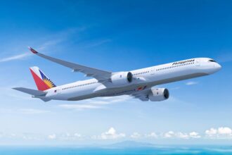 Philippine Airlines Airbus A350-1000 in flight against a blue sky.